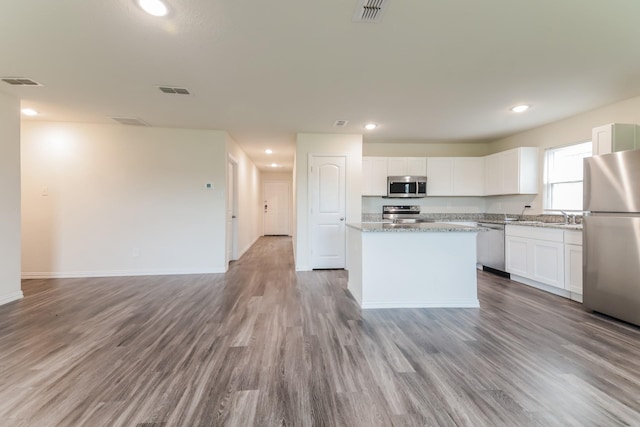 155 Westview Dr, Gun Barrel City, TX 75156 - kitchen featuring appliances with stainless steel finishes, wood finished floors, white cabinetry, a kitchen island, and recessed lighting
