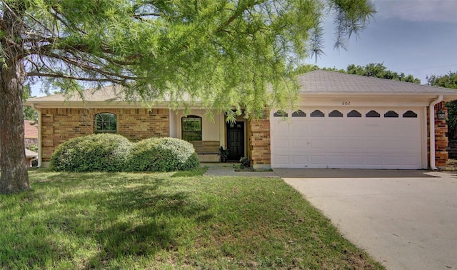 602 Valleyridge Ct, Decatur, TX 76234 - ranch-style home featuring brick siding, concrete driveway, a garage, and a front yard