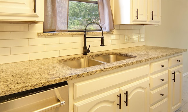 602 Valleyridge Ct, Decatur, TX 76234 - kitchen with a sink, stainless steel dishwasher, backsplash, and light stone counters