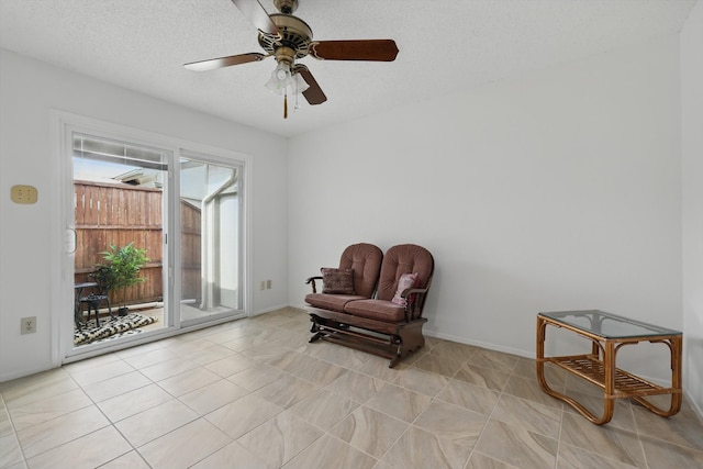 4448 Wind River Ln, Garland, TX 75042 - sitting room with a ceiling fan, baseboards, a textured ceiling, and light tile patterned floors