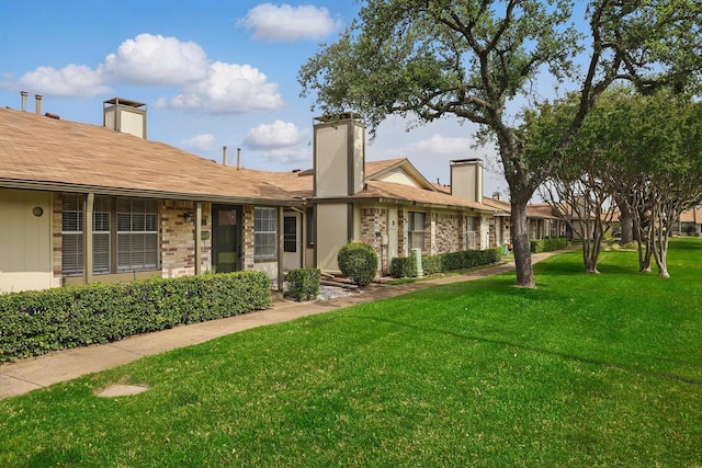 4448 Wind River Ln, Garland, TX 75042 - view of front facade featuring a chimney and a front lawn