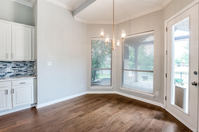4145 Victory Dr, Frisco, TX 75034 - unfurnished dining area with dark wood-type flooring, a chandelier, crown molding, and baseboards