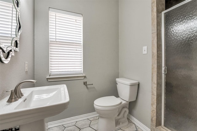 4145 Victory Dr, Frisco, TX 75034 - bathroom with a sink, a shower stall, toilet, and baseboards