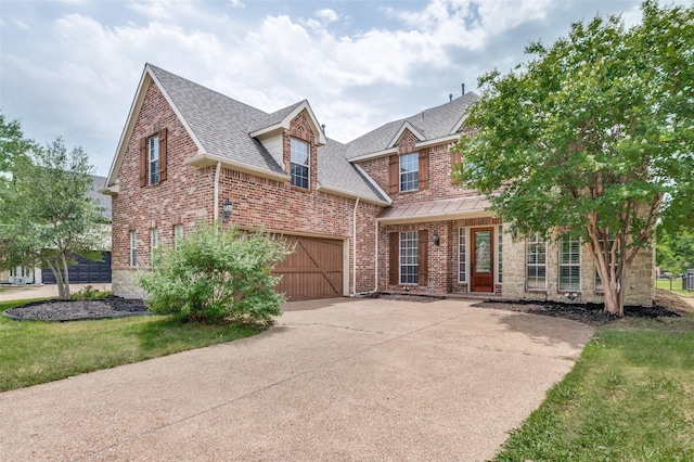 4145 Victory Dr, Frisco, TX 75034 - view of front of property with driveway, roof with shingles, brick siding, a standing seam roof, and a front yard