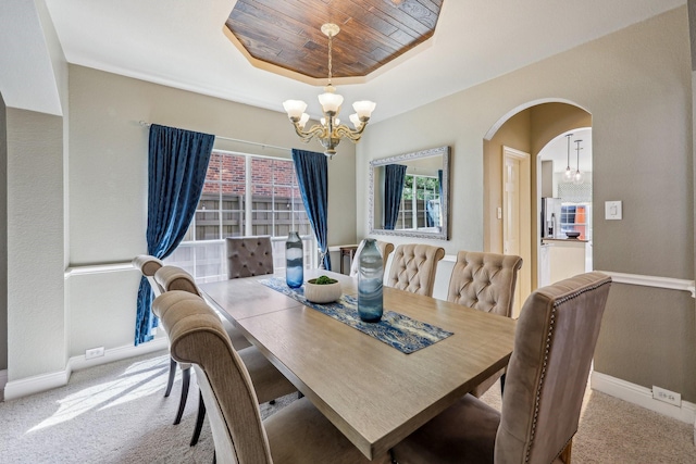 5603 Blazing Star Rd, Frisco, TX 75036 - carpeted dining room featuring a chandelier, a raised ceiling, baseboards, and arched walkways