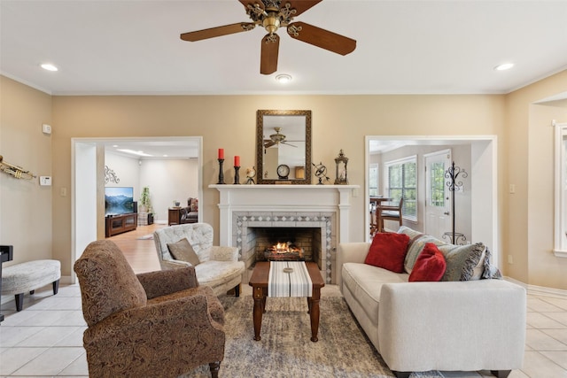 7632 Westwind Dr, Fort Worth, TX 76179 - living room featuring light tile patterned floors, recessed lighting, a tiled fireplace, crown molding, and ceiling fan