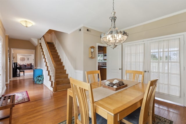 7632 Westwind Dr, Fort Worth, TX 76179 - dining area featuring wood finished floors, ornamental molding, stairs, a chandelier, and baseboards
