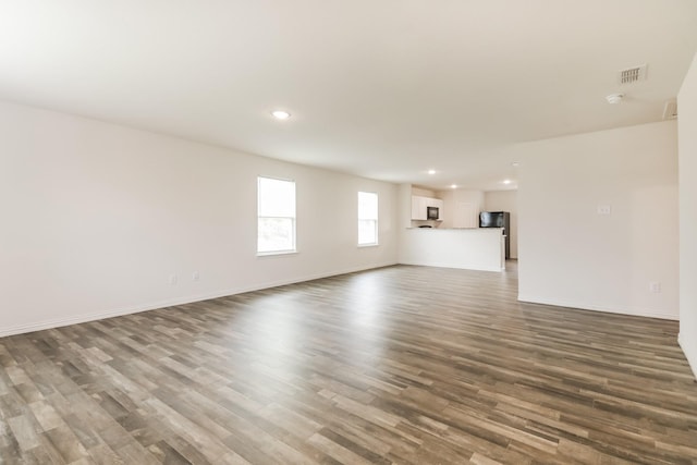 330 Flagship Ln, Gun Barrel City, TX 75156 - unfurnished living room with wood finished floors, baseboards, and recessed lighting