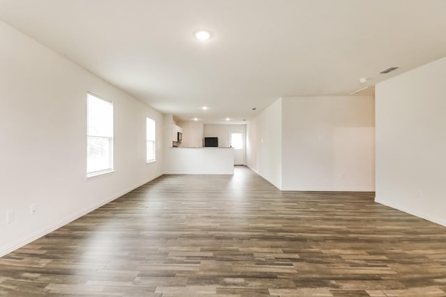 330 Flagship Ln, Gun Barrel City, TX 75156 - unfurnished living room with dark wood-style floors, recessed lighting, and baseboards