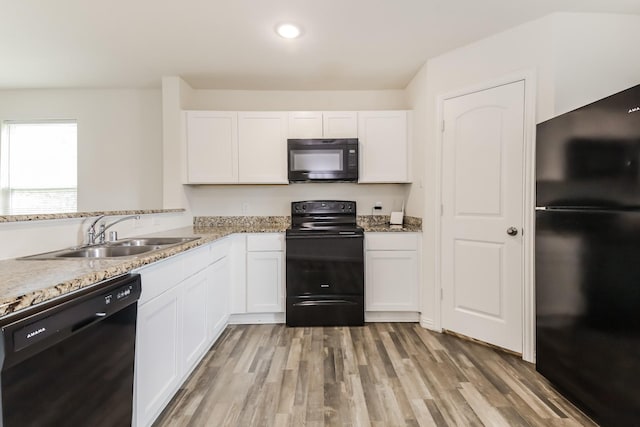 330 Flagship Ln, Gun Barrel City, TX 75156 - kitchen with black appliances, a sink, white cabinets, light wood-type flooring, and recessed lighting