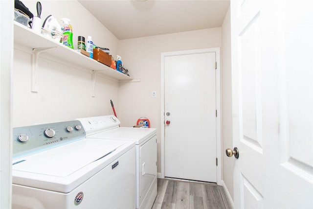 1011 Liffey Dr, Pflugerville, TX 78660 - laundry room featuring washer and clothes dryer and light wood-style floors