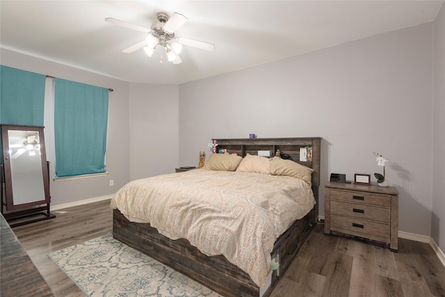 bedroom with wood finished floors, baseboards, and a ceiling fan