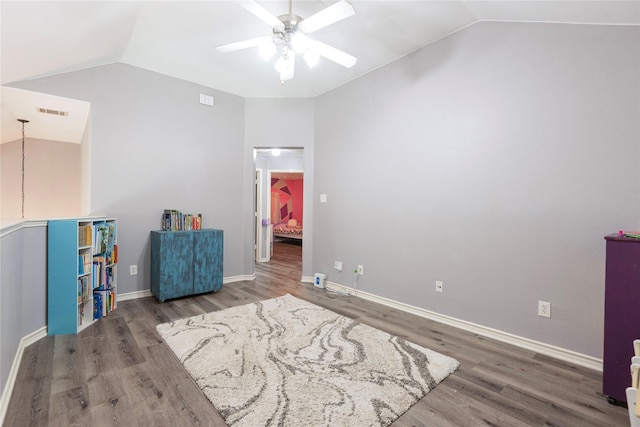 bedroom featuring vaulted ceiling, wood finished floors, baseboards, and ceiling fan