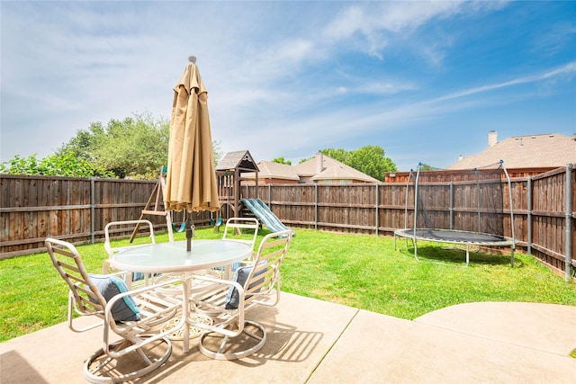 view of patio / terrace featuring a playground, outdoor dining area, and a trampoline