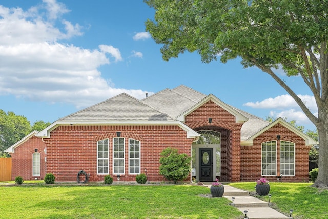 612 Christan Ct, Rockwall, TX 75087 - traditional-style home featuring brick siding, a front lawn, and a shingled roof