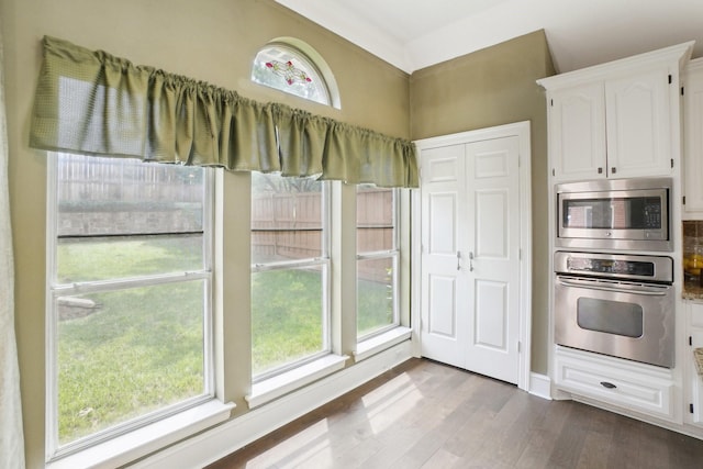 612 Christan Ct, Rockwall, TX 75087 - kitchen featuring stainless steel appliances, white cabinets, and dark wood finished floors