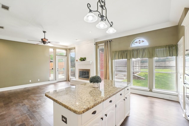612 Christan Ct, Rockwall, TX 75087 - kitchen featuring plenty of natural light, dark wood-style floors, and white cabinetry