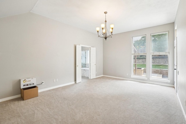 612 Christan Ct, Rockwall, TX 75087 - carpeted empty room with a chandelier, baseboards, and vaulted ceiling