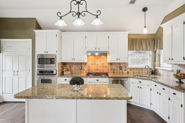 612 Christan Ct, Rockwall, TX 75087 - kitchen featuring appliances with stainless steel finishes, a sink, white cabinets, stone counters, and vaulted ceiling