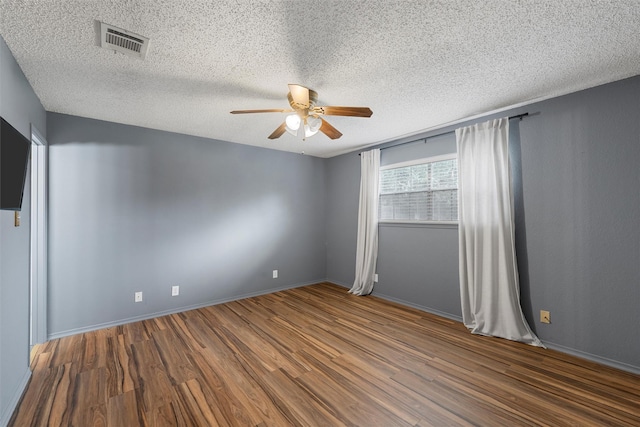 178 Norwood Dr, Woodway, TX 76712 - spare room with a ceiling fan, wood finished floors, a textured ceiling, and baseboards