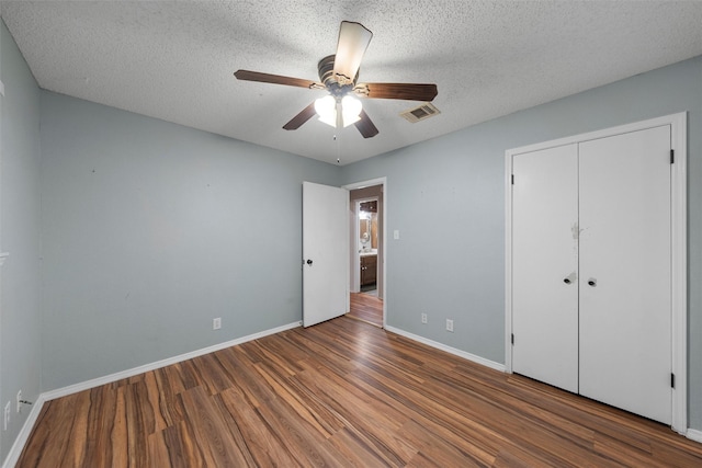 178 Norwood Dr, Woodway, TX 76712 - unfurnished bedroom with wood finished floors, baseboards, a textured ceiling, a closet, and ceiling fan