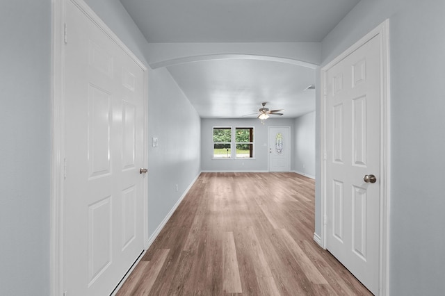 804 Hemlock Dr, West Tawakoni, TX 75474 - unfurnished room with arched walkways, wood finished floors, a ceiling fan, and baseboards