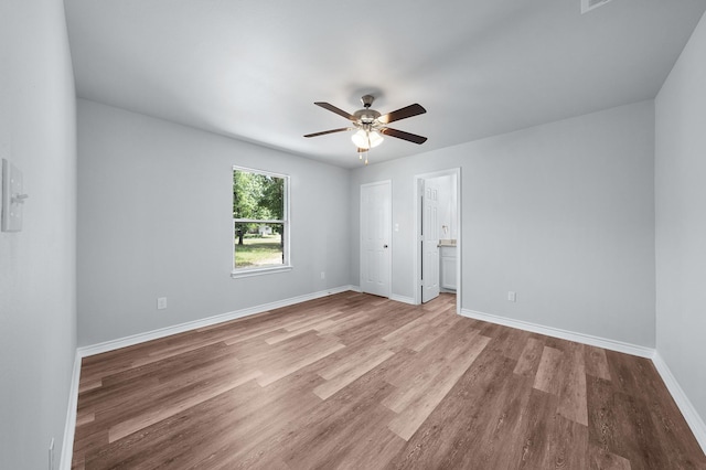 804 Hemlock Dr, West Tawakoni, TX 75474 - unfurnished bedroom with wood finished floors, baseboards, and ceiling fan