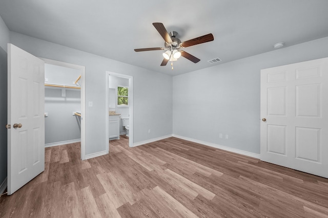 804 Hemlock Dr, West Tawakoni, TX 75474 - unfurnished bedroom with light wood-type flooring, a walk in closet, baseboards, and a closet