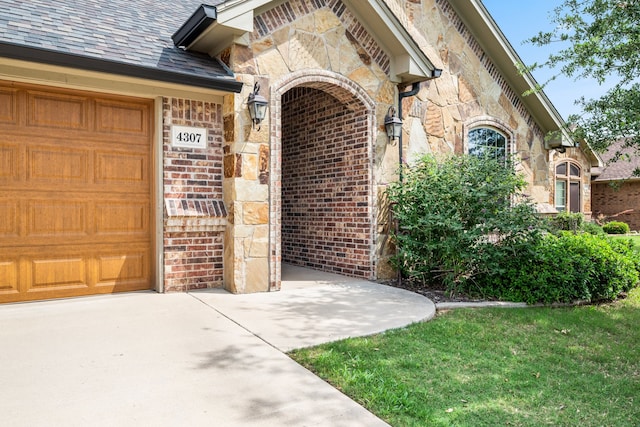 4307 Savannah Ln, Granbury, TX 76049 - entrance to property with stone siding, an attached garage, and brick siding