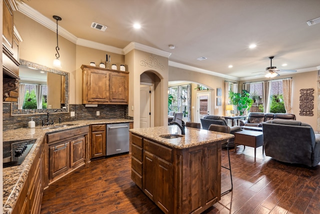 4307 Savannah Ln, Granbury, TX 76049 - kitchen with a sink, black electric cooktop, dishwasher, arched walkways, and recessed lighting