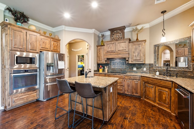 4307 Savannah Ln, Granbury, TX 76049 - kitchen featuring stainless steel appliances, a sink, dark wood-style flooring, tasteful backsplash, and ornamental molding