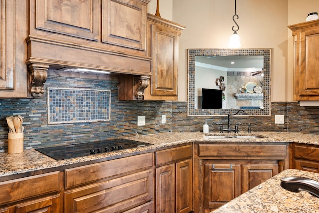 4307 Savannah Ln, Granbury, TX 76049 - kitchen featuring black electric stovetop, decorative backsplash, a sink, ornamental molding, and light stone countertops