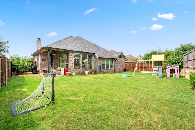 4307 Savannah Ln, Granbury, TX 76049 - back of house featuring a playground, a chimney, brick siding, and a shingled roof