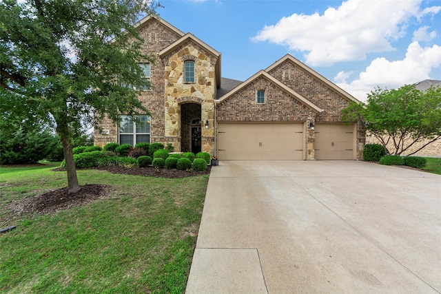 3030 Maverick Dr, Forney, TX 75126 - traditional home featuring an attached garage, driveway, brick siding, a front lawn, and stone siding