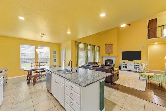 3030 Maverick Dr, Forney, TX 75126 - kitchen with a sink, dishwasher, light tile patterned floors, a chandelier, and a kitchen island with sink