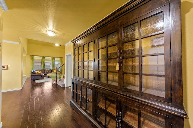 3030 Maverick Dr, Forney, TX 75126 - hall with dark wood-type flooring, crown molding, and baseboards
