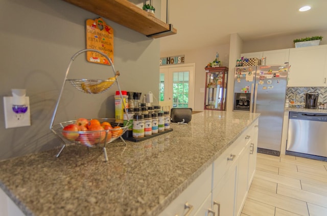 2209 Ridgewood Dr, Sherman, TX 75092 - kitchen featuring stainless steel appliances, white cabinetry, french doors, recessed lighting, and decorative backsplash