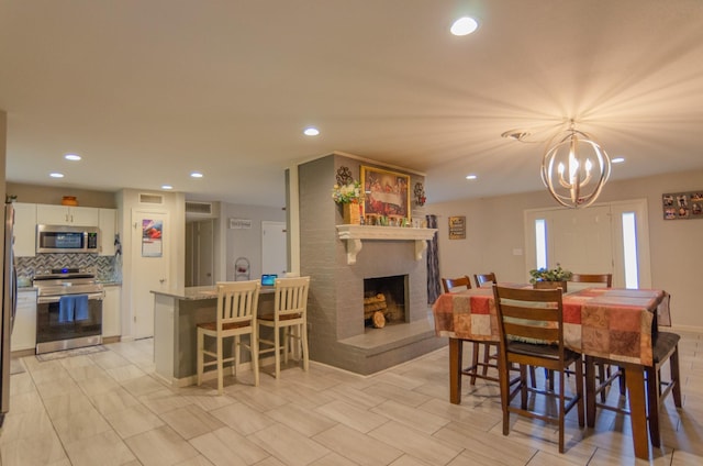 2209 Ridgewood Dr, Sherman, TX 75092 - dining space featuring recessed lighting, a brick fireplace, and a chandelier