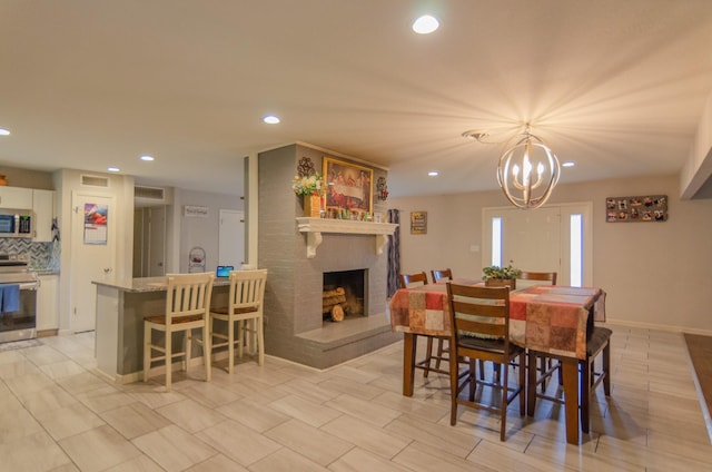 2209 Ridgewood Dr, Sherman, TX 75092 - dining space with a brick fireplace, recessed lighting, and a chandelier