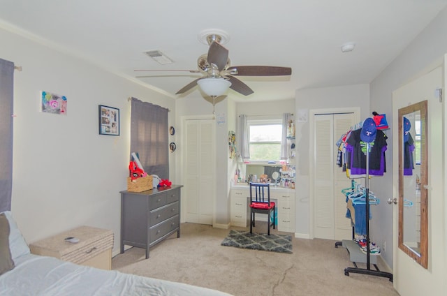 2209 Ridgewood Dr, Sherman, TX 75092 - carpeted bedroom featuring two closets, ceiling fan, and baseboards