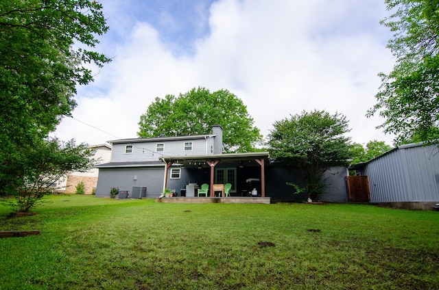 2209 Ridgewood Dr, Sherman, TX 75092 - rear view of property with a chimney, a lawn, a patio area, and cooling unit