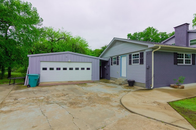 2209 Ridgewood Dr, Sherman, TX 75092 - view of home's exterior with a detached garage, an outbuilding, brick siding, and a chimney