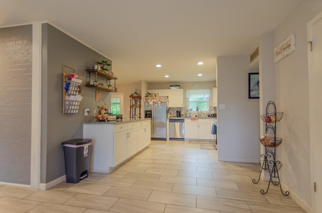 2209 Ridgewood Dr, Sherman, TX 75092 - kitchen with appliances with stainless steel finishes, white cabinets, recessed lighting, decorative backsplash, and baseboards