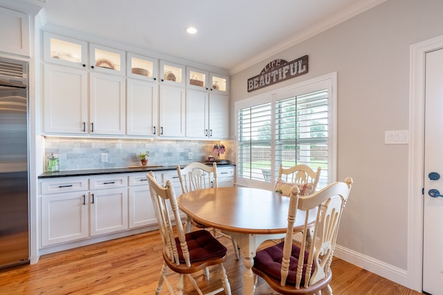 112 Mustang Dr, Fate, TX 75087 - dining room with ornamental molding, light wood finished floors, baseboards, and recessed lighting
