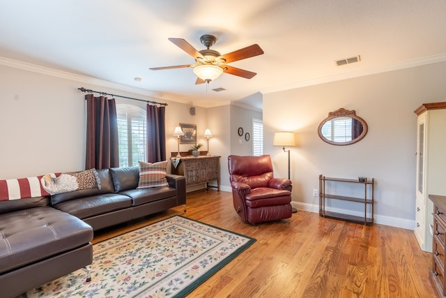 112 Mustang Dr, Fate, TX 75087 - living room featuring plenty of natural light, a ceiling fan, ornamental molding, light wood-style floors, and baseboards