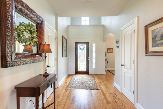 112 Mustang Dr, Fate, TX 75087 - entrance foyer with arched walkways, light wood finished floors, and baseboards