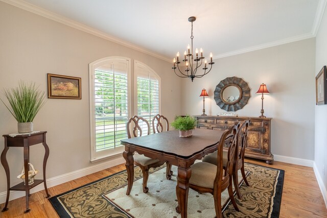 112 Mustang Dr, Fate, TX 75087 - dining area featuring a chandelier, crown molding, baseboards, and light wood finished floors