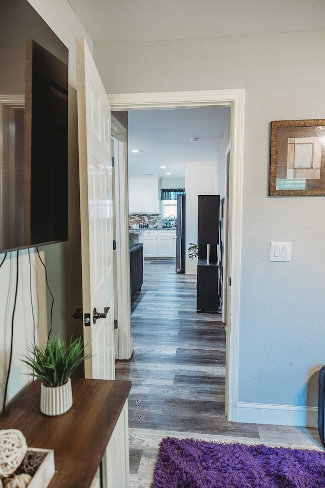 1313 E Turley St, Sherman, TX 75090 - hallway featuring wood finished floors and baseboards