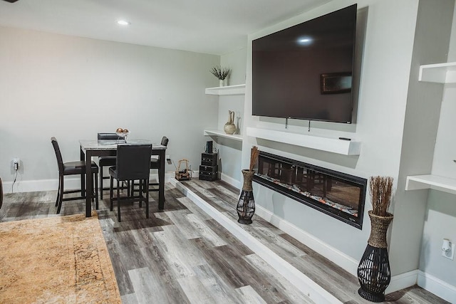 1313 E Turley St, Sherman, TX 75090 - dining room featuring wood finished floors, a glass covered fireplace, baseboards, and recessed lighting
