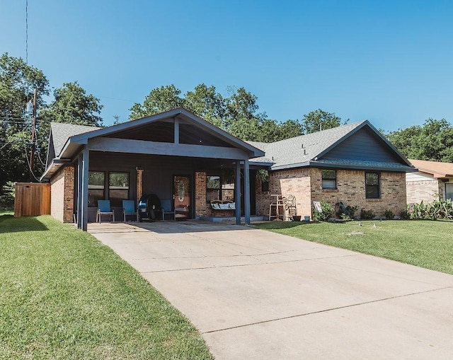 1313 E Turley St, Sherman, TX 75090 - rear view of house featuring driveway, a lawn, a carport, and brick siding